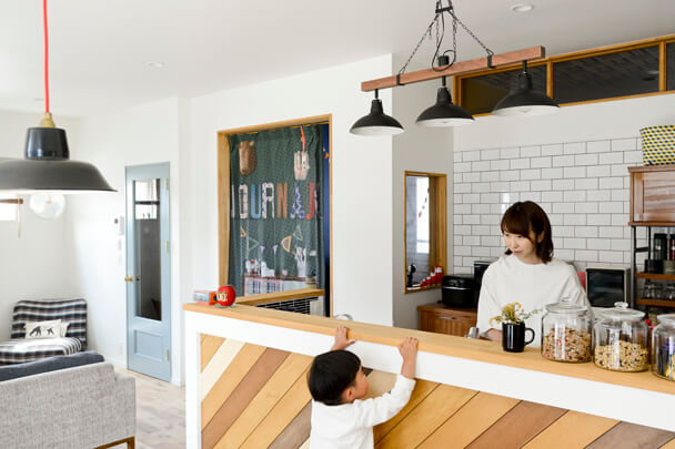 メンズライクな木製のアクセントと黒板のあるキッチンと子供のいる暮らし