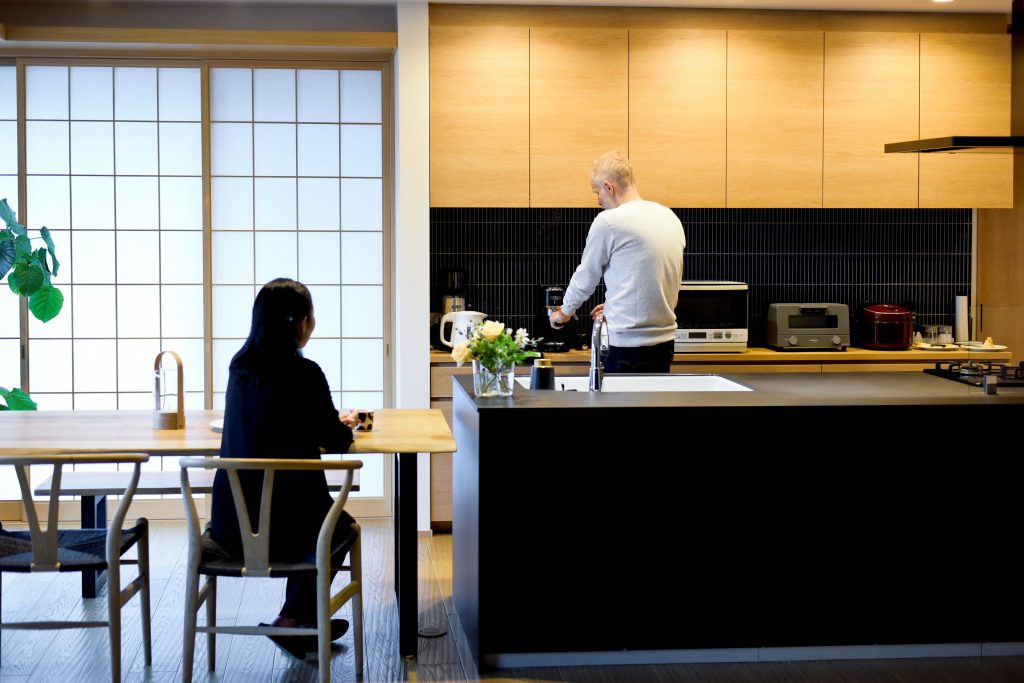 キッチンで作業をするご夫婦。異文化の要素を取り入れ、機能性と美しさを両立したグローバルなライフスタイル。